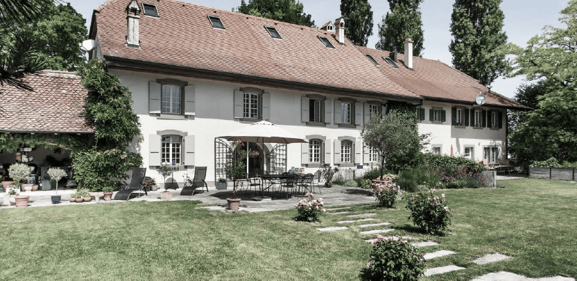 A welcoming house surrounded by a flower garden